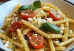 Basilikum-Sesam-Pasta mit Feta auf einem Teller garniert