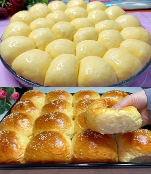 Leckere frisch gebackene Milchbrötchen auf einem Holzbrett angerichtet