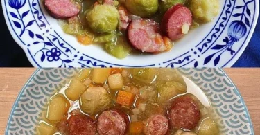 Gemüseeintopf mit Mettwurst in einer bunten Schüssel serviert.