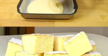 Ein Stück heißer Milchkuchen auf einem Teller, warm serviert mit Puderzucker.