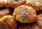 Knusprige Zucchini-Feta-Bällchen frisch aus dem Ofen serviert.