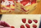 Obstkuchen mit frischen Erdbeeren, Bananen und Mandarinen auf einem Teller