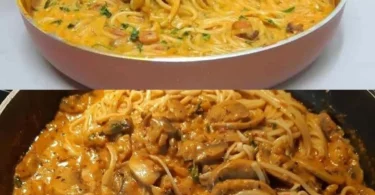 Spaghetti mit Champignons und Parmesan auf einem Teller garniert