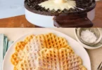 Leckere, frisch gebackene Waffeln auf einem Teller mit Sahne und Früchten