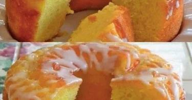 Zitronen Joghurtkuchen auf einem Teller, dekoriert mit Zitronenscheiben und Minze