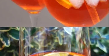 Ein erfrischender Aperol Spritz in einem eleganten Glas mit Zitrone und Eis.