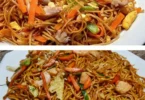 Chinesische gebratene Nudeln mit Hähnchen, Ei und buntem Gemüse auf einem Teller
