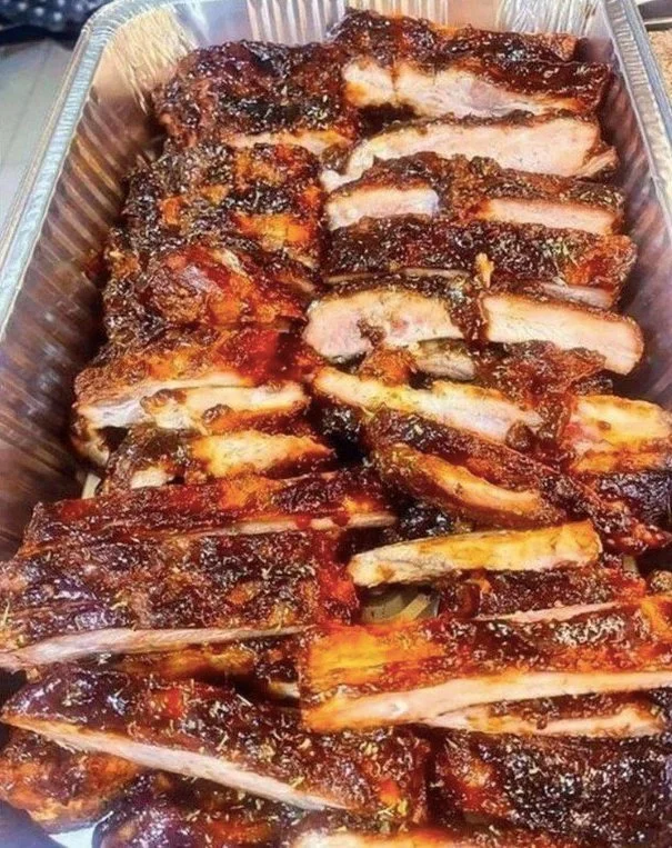 Zarte Honig-Knoblauch-Rippchen auf einem Grill serviert