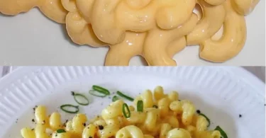Leckere Portion Makkaroni Käse auf einem Teller, serviert mit Kräutern.