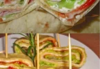 Leckere Party-Wraps mit Frischkäse und Putenbrust auf einem Teller serviert