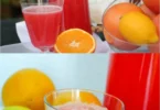Erfrischende pink lemonade in einem Glas mit Zitronenscheiben und Minze