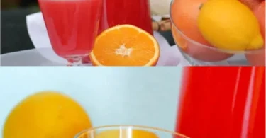 Erfrischende pink lemonade in einem Glas mit Zitronenscheiben und Minze