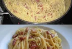 Traditionelle Spaghetti Carbonara im Südtiroler Stil serviert mit Speck und Parmesan.