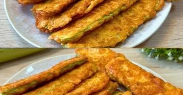 Panierte Zucchinischeiben mit Parmesan auf einem Teller serviert