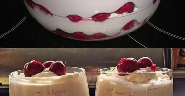 Sahne-Schichtdessert mit Mascarpone und Sauerkirschen in einem eleganten Glas serviert.
