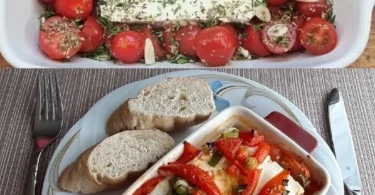 Einfach gebackener Feta mit Kräutern und Tomaten auf einem Teller.