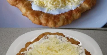 Leckere Langos mit Knoblauchöl und Crème Fraîche, serviert auf einem Teller.