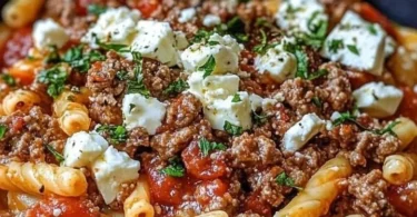 Griechische Nudelpfanne mit Hackfleisch und Feta auf einem Teller serviert