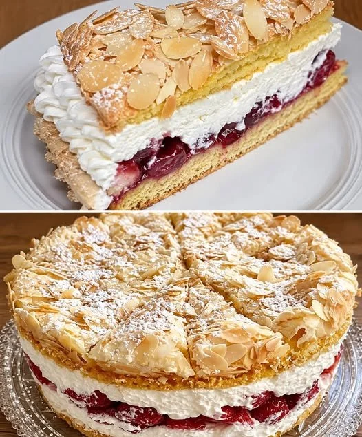 Himmelstorte mit Sauerkirschen auf einem weißen Teller, garniert mit Sahne.