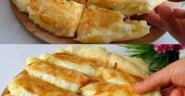 Leckeres Käsebrot mit frischem Käse und Kräutern auf einem Holzbrett