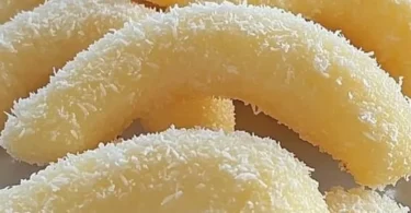 Leckere Kokos-Sahnekipferl auf einem Teller, perfekt zum Naschen.