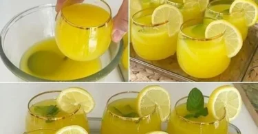 Erfrischende Limonade in einem Glas mit Zitronenscheiben und Minze