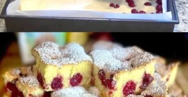 Ein Stück Quark Kirschkuchen auf einem Teller mit frischen Kirschen daneben.