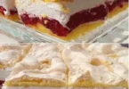 Sahne-Kirschtorte mit frischen Kirschen und Sahne garnierte Torte auf einem Teller