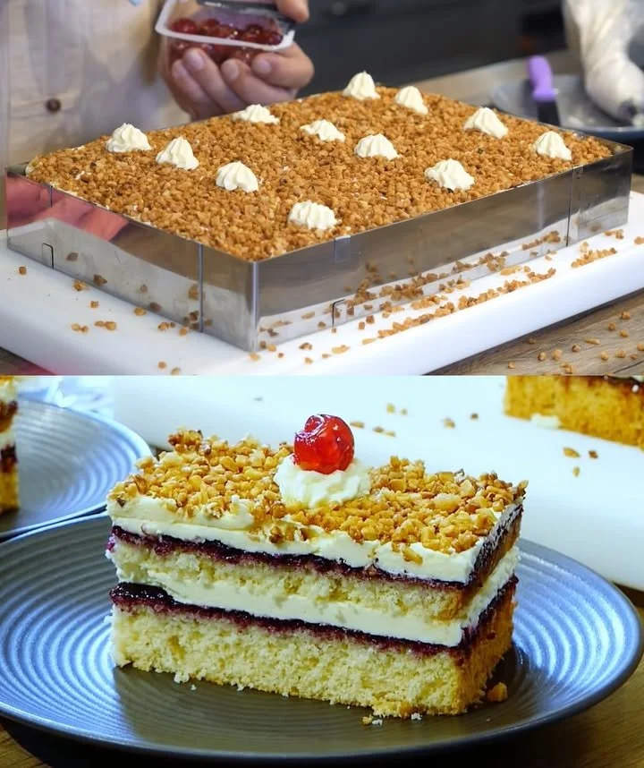 Schichtkuchen mit Buttercreme und Haselnüssen auf einem Teller serviert