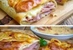 Gefüllter Blätterteigstrudel mit Schinken und Käse auf einem Teller angerichtet